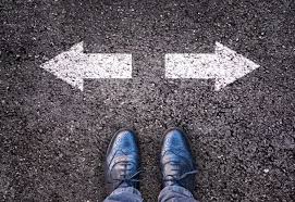 standing and looking down at arrows in both directions